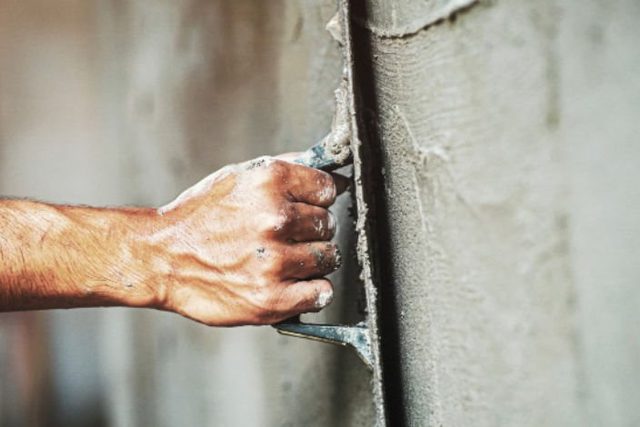 Render being applied to a wall by hand